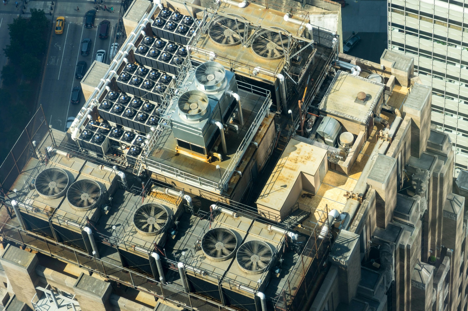 Rooftop HVAC chillers and cooling fans on an urban building