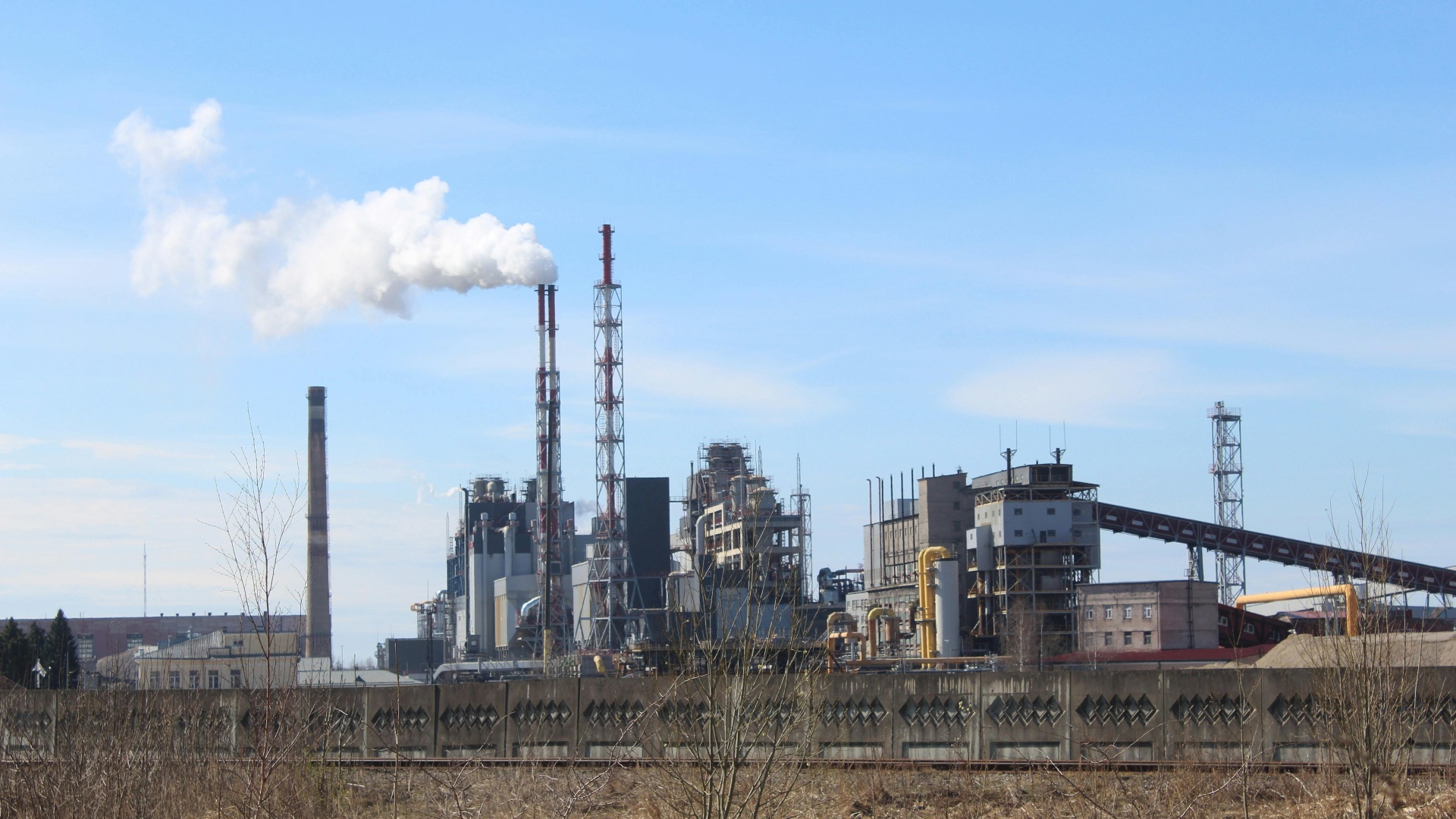 Pulp and paper mill with stacks releasing steam